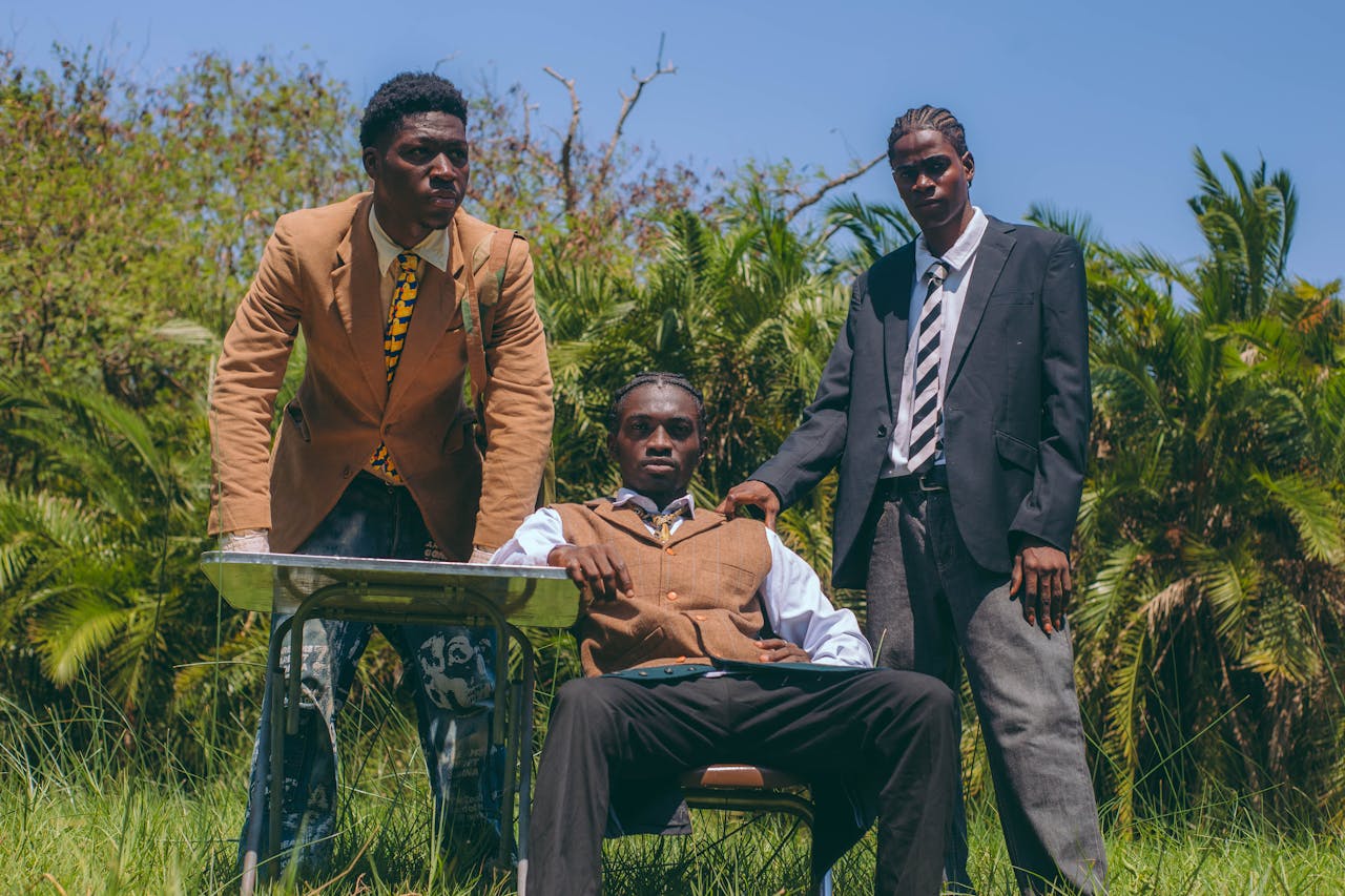Services-03 Stylish young men in suits pose confidently outdoors in Accra, Ghana.