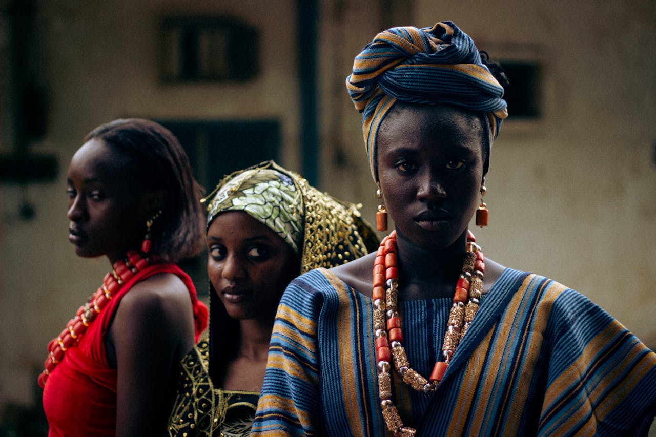 Services-02 Portrait of three women in vibrant African attire and jewelry, showcasing cultural heritage.